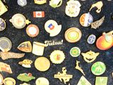 many different types of pins on a black surface