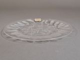 a clear glass plate with a small piece of cheese on it