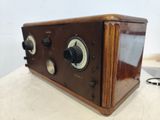 an old fashioned radio sitting on top of a table next to a keychain