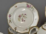a lot of plates and cups on the table