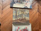 three paintings on the floor next to a vase of flowers