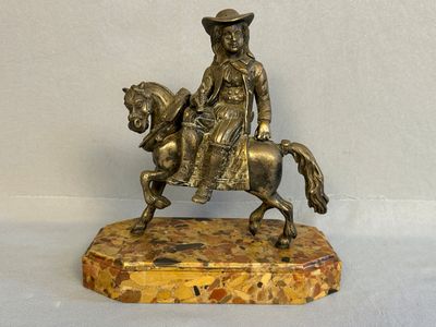 bronze statue of a man riding a horse on a marble base