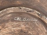 a close up of a metal plate with writing on it