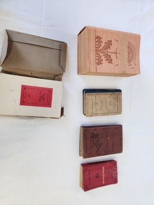 five boxes of books on a white table
