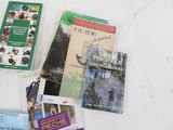 many books that are laying on a white table