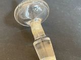 a small glass bottle with a glass stopper attached to it