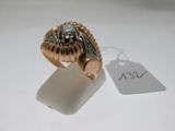 a gold ring with a skull on it and a price tag