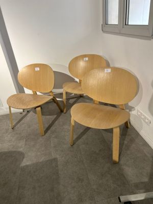 three wooden chairs and a table in a room with a window