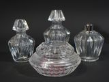 three glass jars with lids sitting on a black surface