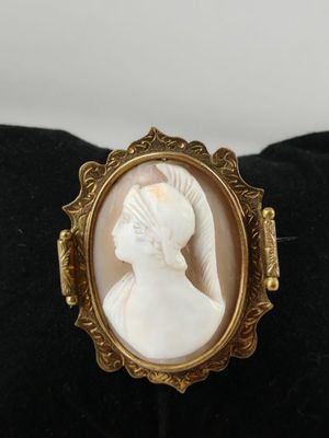 a close up of a ring with a woman ' s profile in it