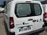 several white vans parked in a parking lot next to each other