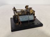 an old model of a steam engine sitting on top of a table