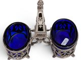 pair of blue glass bowls with a silver stand on a white background