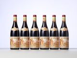 six bottles of red wine lined up in a row