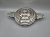 a silverplated casserole dish with a lid