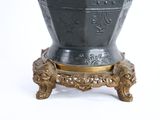 a vase that is sitting on a stand on a white surface
