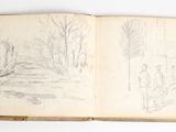 an open book with a drawing of a forest in the background