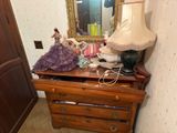 a dresser with a lamp on top of it in a room