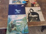 a lot of records on a table in a room