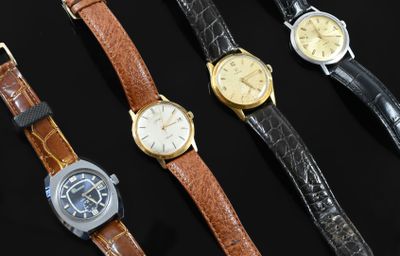 several different types of watches are lined up on a black surface