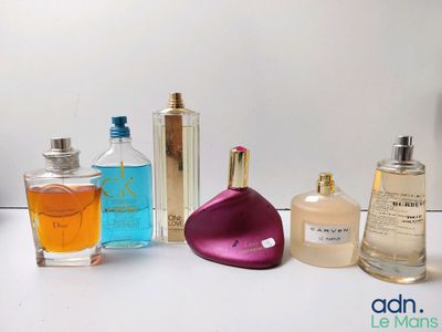 several different types of perfumes are lined up on a white surface