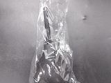 a plastic bag on a metal table with a knife in it