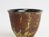 brown and black ceramic bowl on a white background