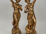 pair of antique bronze figurines of a woman and a man