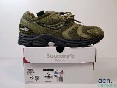 the shoe is sitting on top of a box on a white surface