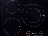 a black induction cooktop with three burners on a white background