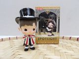 a small figurine of a boy with a top hat and bow tie