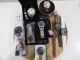 a lot of watches that are sitting on a table