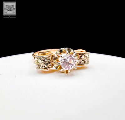 yellow gold engagement ring with a pink diamond center stone