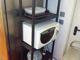 un micro-ondes et un four à micro-ondes posés sur une étagère dans une cuisine