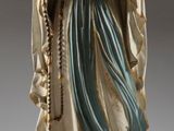 La statue de la Vierge Marie tient un chapelet dans ses mains.
