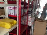 a room with many shelves and boxes on the shelves