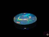 an image of a black opal in the dark