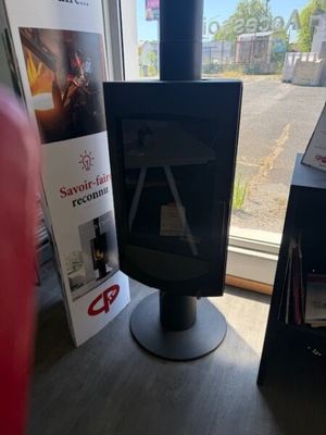 a television sitting on a stand in front of a window