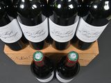 several bottles of wine are lined up in a wooden crate