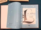 an open book with a picture of a letter l on it