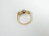 a close up of a gold ring with pearls on it