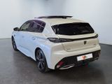 the rear end of a white car in a showroom