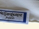 a label on a white shirt that says yes saint laurent