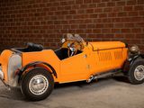 an orange toy car parked in front of a brick wall