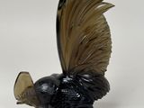 a black and gold turkey figurine on a white surface