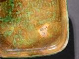 a green and brown bowl with a tag on it