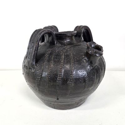 a black vase that is sitting on a table