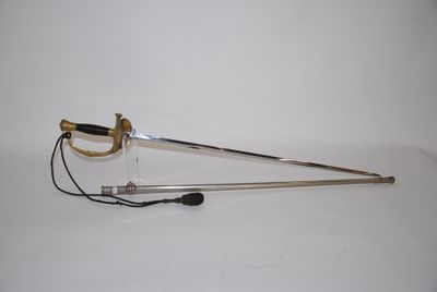 a sword that is laying on a white surface