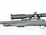 the rifle is sitting on a white surface with a red dot on it