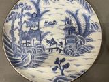 three plates with blue and white designs on them on a table